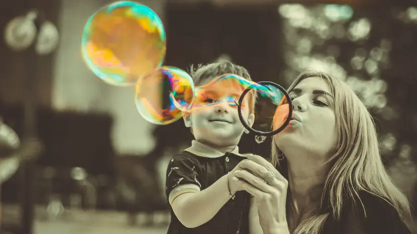 Child and adult blowing bubbles