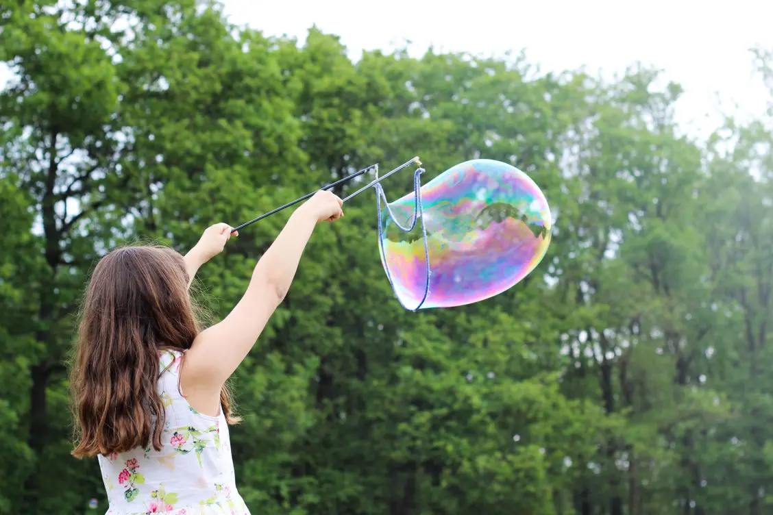 Child blowing large bubble